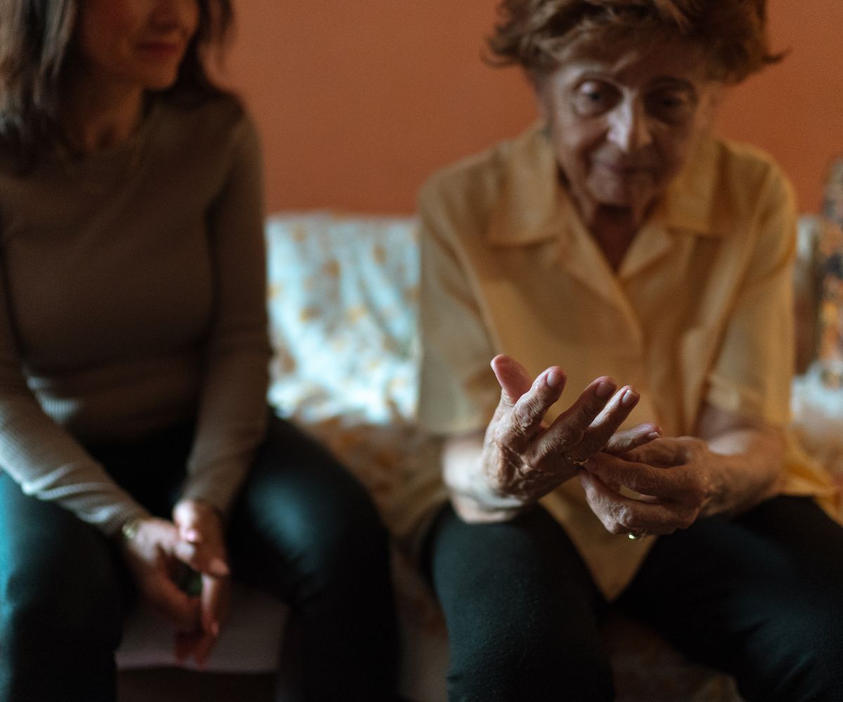 A Chikel caregiver sharing a warm moment with an elderly client at home